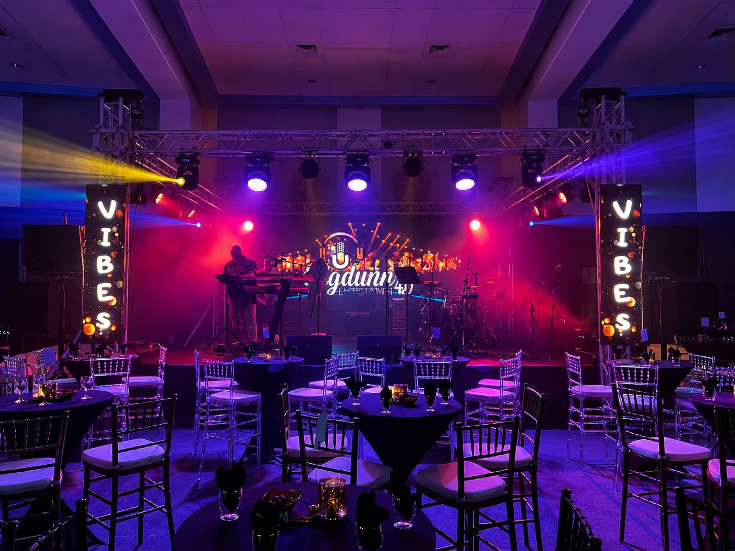 Indoor live performance stage with concert lighting and LED columns